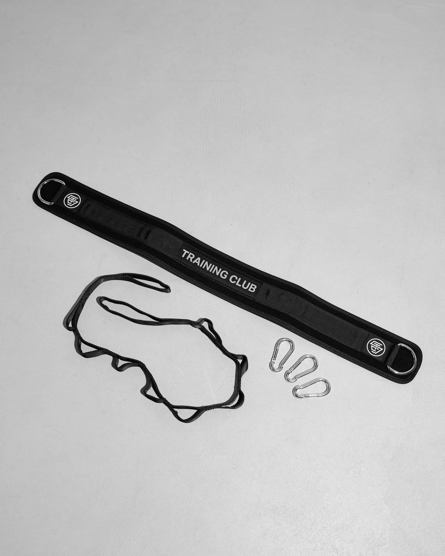 Black weight belt with 'Training Club' branding on a light gray background