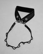 Black weight belt with metal clip on a gray background